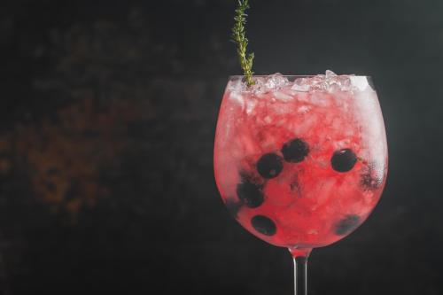 a glass filled with a drink in the shape of a lady bug drink at Carlota Sustainable Design Hotel in Quito