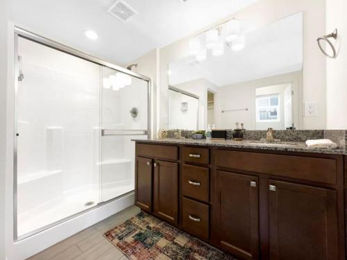 a bathroom with a shower and a sink and a mirror at Tiny Timber Tree Home NEW in Flagstaff