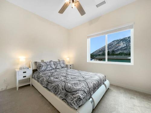 a white bedroom with a bed and a window at Tiny Timber Tree Home NEW in Flagstaff