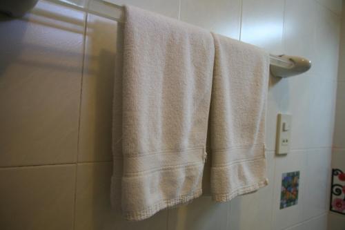 a towel hanging on a towel rack in a bathroom at Mui Ne Resort in Mui Ne