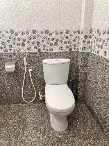 a bathroom with a white toilet in a shower at Shan Star Weligama in Weligama