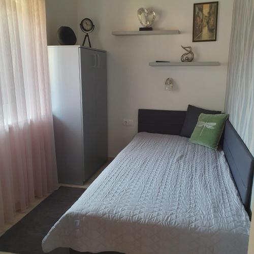a bedroom with a bed with a green pillow at Várda-Lak in Kisvárda