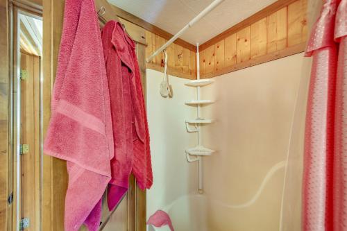a bathroom with pink towels and a shower at Libby Home with Mountain Views Gazebo and Fire Pit! in Libby