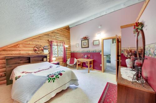 a bedroom with a bed and a wooden wall at Libby Home with Mountain Views Gazebo and Fire Pit! in Libby