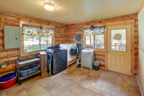 a kitchen with a washer and dryer in a cabin at Libby Home with Mountain Views Gazebo and Fire Pit! in Libby