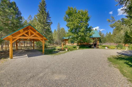 a pavilion and a gazebo on a gravel road at Libby Home with Mountain Views Gazebo and Fire Pit! in Libby
