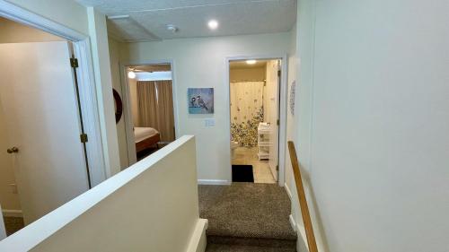 a hallway with a stairway leading to a room at The Blue Door at Sylva Home Base Apartments in Sylva
