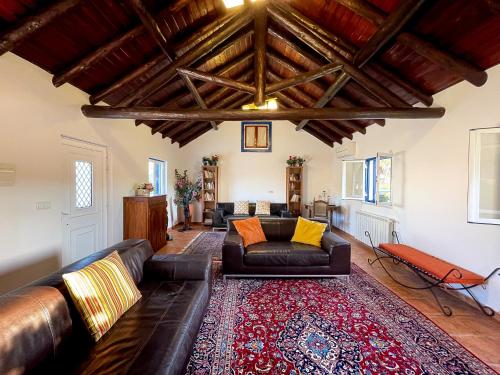 a living room with a couch and a rug at Quinta do Cutato - Piscina Guest House in Santo Estêvão