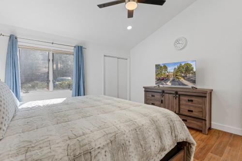 a bedroom with a bed and a window and a dresser at Brand New Listing Country Club Condo in Flagstaff