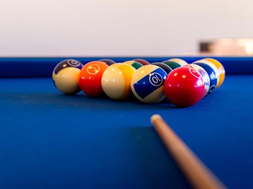 a group of billiard balls on a pool table at Quinta do Cutato - Piscina Guest House in Santo Estêvão