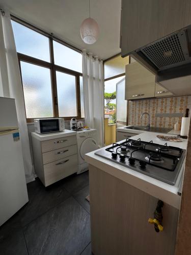 a kitchen with a stove and a stove top oven at L'Orchidea_Holiday in Camaiore