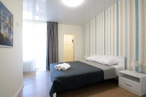 a bedroom with a bed with two towels on it at Lviv center VIP apartments new building in Lviv