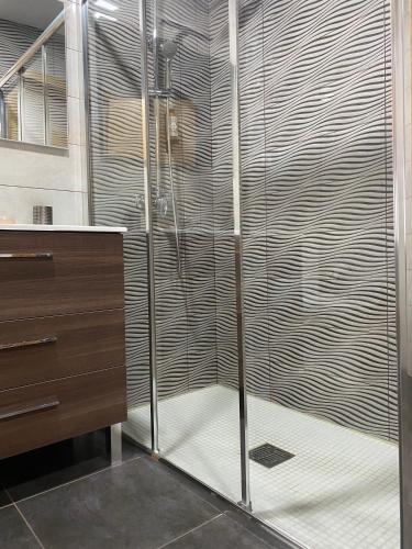 a shower with a glass door in a bathroom at Casinha da Ti'Augusta in Lamego