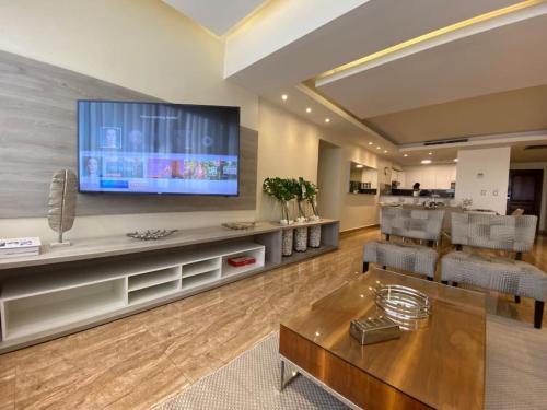 a living room with a large flat screen tv at Lovely Sto Dgo Center Apt in Santo Domingo