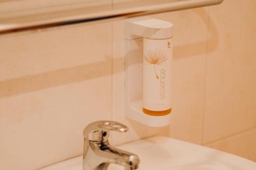 a bathroom sink with a faucet next to a sink at Golf Hotel Austerlitz in Slavkov u Brna