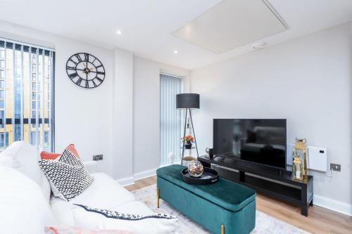 a living room with a couch and a tv at The Stylish Spot 1 Bed Apt in Leeds City Centre in Leeds