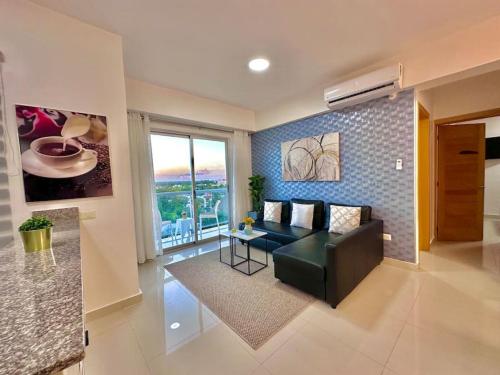 a living room with a couch and a table at Cozy Hideaway Apt Near Beach in Boca Chica