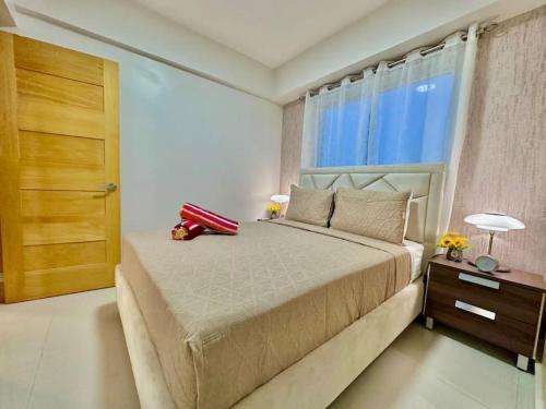 a bedroom with a bed with a red suitcase on it at Cozy Hideaway Apt Near Beach in Boca Chica