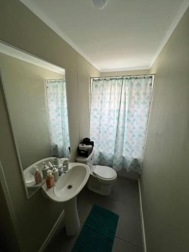 a small bathroom with a sink and a toilet at Casa Nueva 3 dormitorios 2B in Puerto Montt