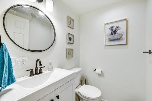 a white bathroom with a sink and a mirror at Central Tacoma Getaway - 3 Mi to Downtown! in Tacoma