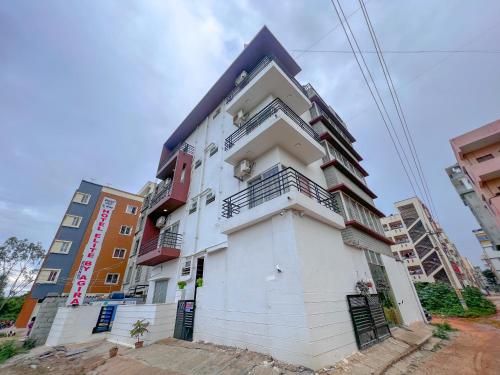 a white building with a black roof at Hotel Elite By Agira Hotels-Free Airport Pickup or Drop in Yelahanka