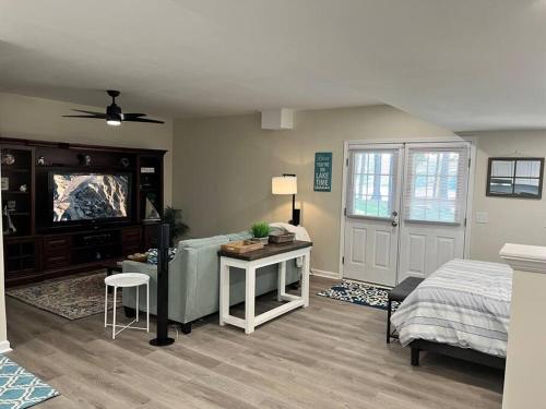 a bedroom with a bed and a desk and a tv at Lakeside serenity in Newnan in Newnan