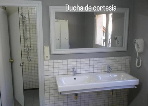 a bathroom with a white sink and a mirror at Riu Nere Mountain Apartments in Vielha