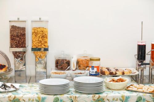 a table topped with plates and bowls of food at Vomero High Hotel in Naples