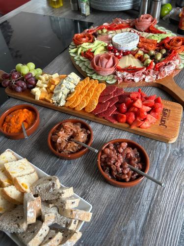 a table topped with different types of appetizers and food at Brownrigg in Otterburn