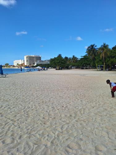 a person playing with a kite on the beach at Beach One Bedroom 2 in Ocho Rios