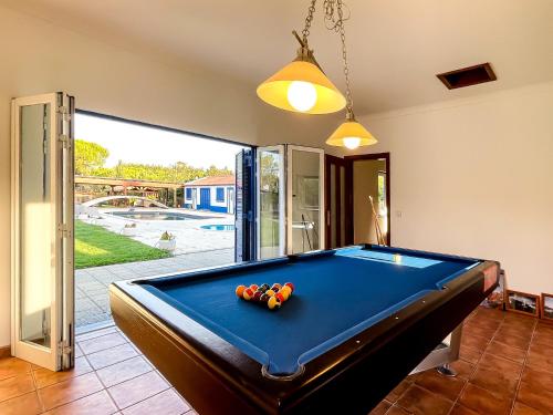 a pool table in the middle of a living room at Quinta do Cutato - Beatriz Guest House - A2 in Santo Estêvão