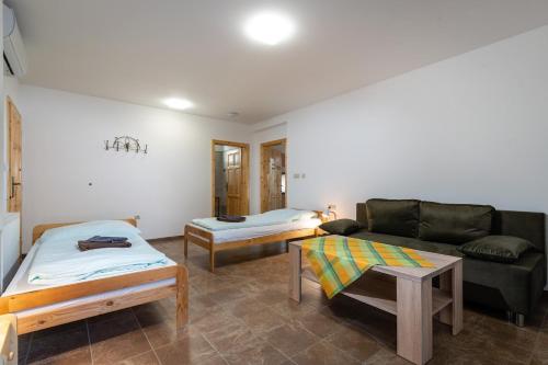 a living room with a couch and a bed at Rezidencia Podhájska in Podhájska