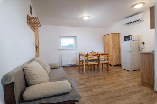 a living room with a couch and a table and a kitchen at Rezidencia Podhájska in Podhájska