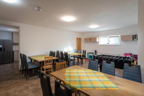 a dining room with wooden tables and chairs at Rezidencia Podhájska in Podhájska