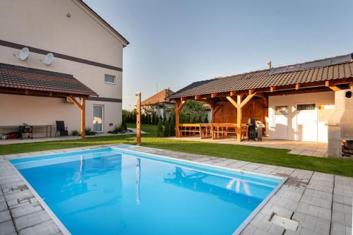 a swimming pool in the backyard of a house at Rezidencia Podhájska in Podhájska
