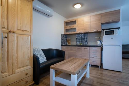 a kitchen with a couch and a table in a room at Rezidencia Podhájska in Podhájska