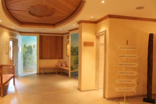 a hallway with a room with a table and a ceiling at Garden & SPA Hotel Das Götzfried in Regensburg