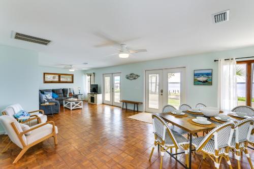 a living room with a table and chairs at Private Beach and Dock Waterfront Panacea Retreat! in Panacea