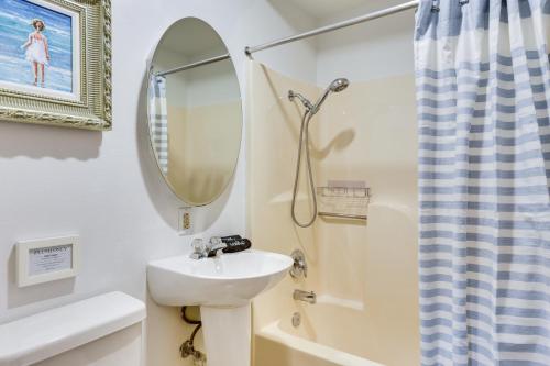 a bathroom with a sink and a mirror at Private Beach and Dock Waterfront Panacea Retreat! in Panacea