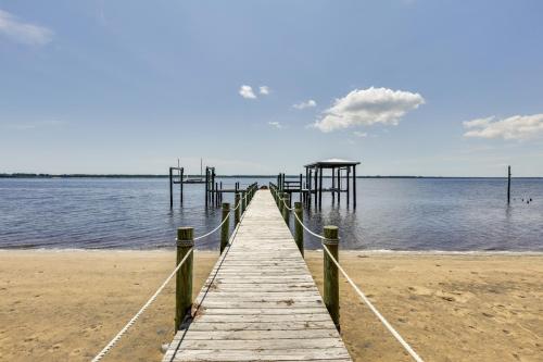 a wooden pier on the beach with the water at Private Beach and Dock Waterfront Panacea Retreat! in Panacea