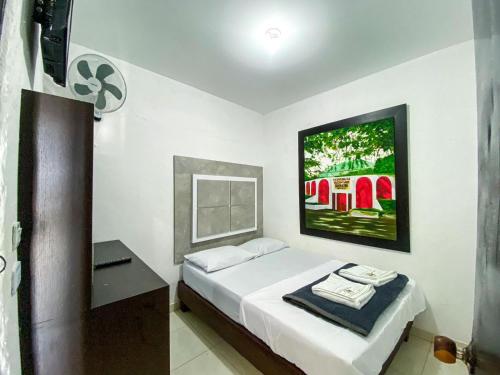 a bedroom with a bed and a tv on the wall at Hotel Campestre La María Toro Valle in Toro