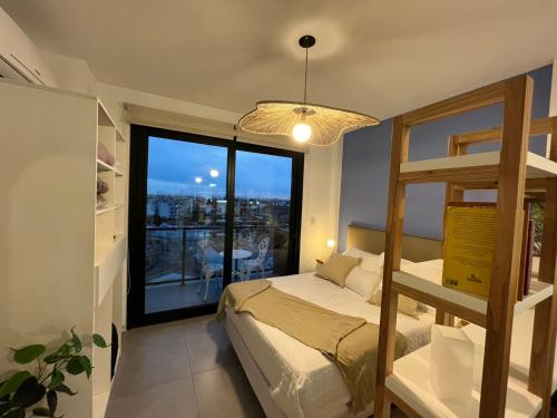 a bedroom with a bunk bed and a large window at Ministro Brin Suite MT in Remedios de Escalada