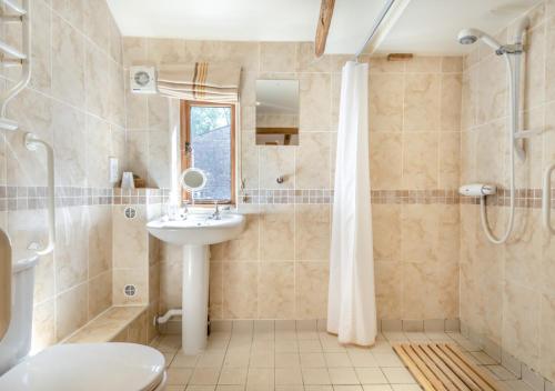 a bathroom with a sink and a shower at Shepherds Watch in Saint James