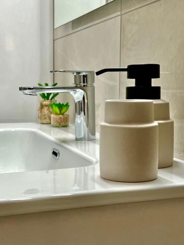 a bathroom sink with a faucet on a counter at Aliki's House in Kalabaka
