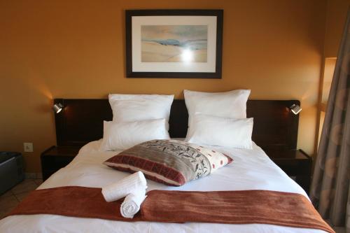 
A bed or beds in a room at Namib Naukluft Lodge
