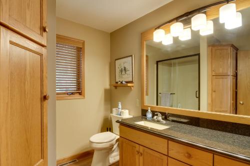 a bathroom with a sink and a toilet and a mirror at Lakefront Home with Beach, Deck and Fire Pit! in Alexandria