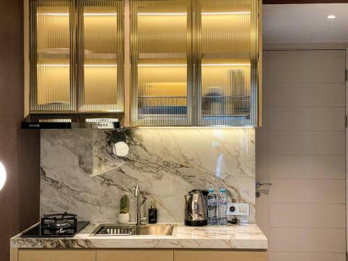 a kitchen with a sink and a counter top at Modern Cozy La Casa VI at Benson Tower in Surabaya