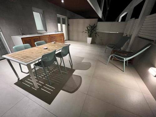 a dining room with a wooden table and chairs at SeaCity Vibes Apartments in Monopoli