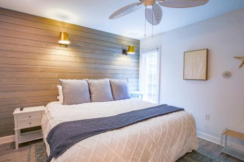 a bedroom with a large bed with a wooden headboard at Sapphire Seascape in Kiawah Island