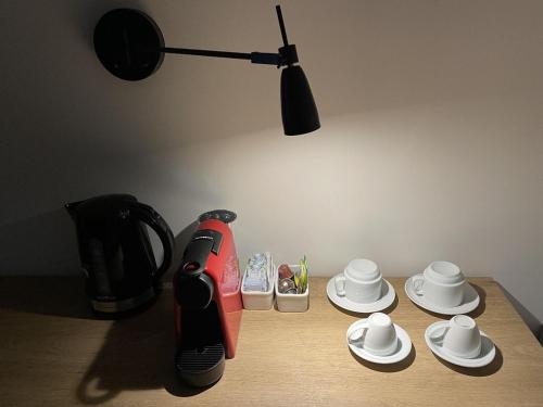 a table with a coffee maker and cups on it at Transamerica Executive Maringá in Maringá